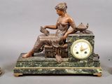 a statue of a woman sitting on top of a table next to a clock