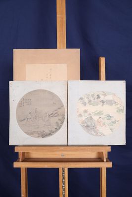 painting on a easel with two paintings on it against a blue backdrop