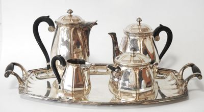 a silver tray with a silver tea set on it