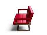 a red chair and a red ottoman on a white surface