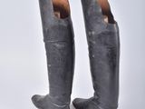 pair of black leather riding boots on a white background