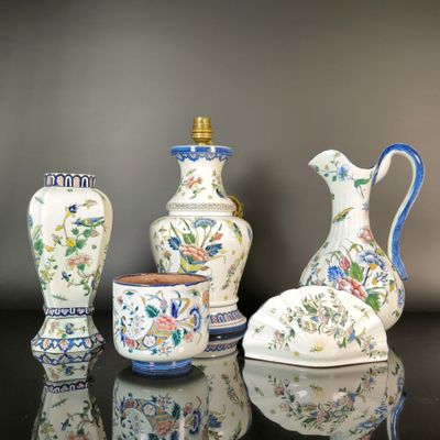 three vases sitting on a table with a vase in front of them