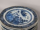 several blue and white plates stacked on top of each other on a table