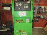 a green machine that is sitting in a garage