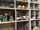 many shelves with pots and pans on them in a room