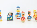 a group of toy figurines of donald and daisy duck