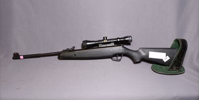 a close up of a rifle on a white background with a gun in the foreground
