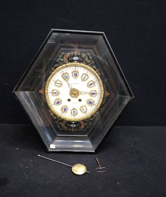 a clock that is sitting on a table with a black background