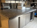 a kitchen with stainless steel cabinets and a granite counter top