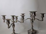 a silver candelab with five candles on it