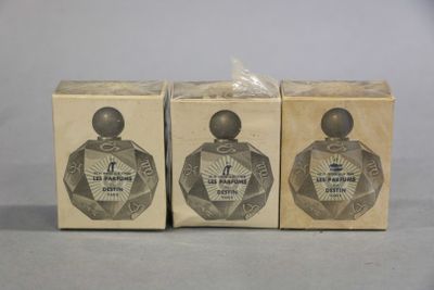 two boxes of perfume sitting next to each other on top of a table