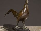 statue of a bird on a marble base on a table