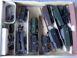 a lot of toy trains in a box on the table