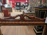 a wooden bench that is in a room with red walls