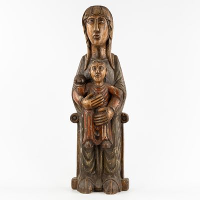 a wooden statue of a woman holding a child