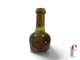 a bottle of wine that is sitting on a white surface