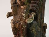 a statue of a man holding a snake in his hand