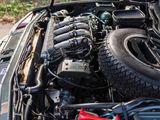 a car engine with its hood open on the street