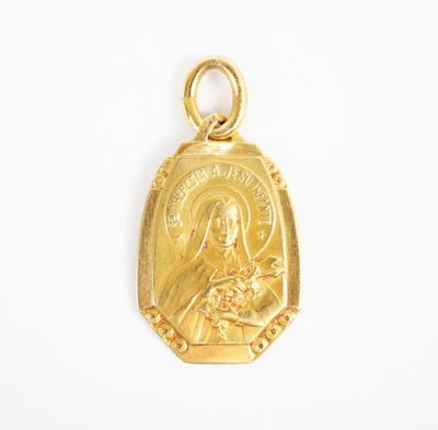 a gold plated pendant with a picture of the virgin and child