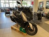 a motorcycle that is sitting on a pallet in a showroom