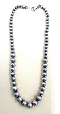 a close up of a necklace on a mannequin mannequin