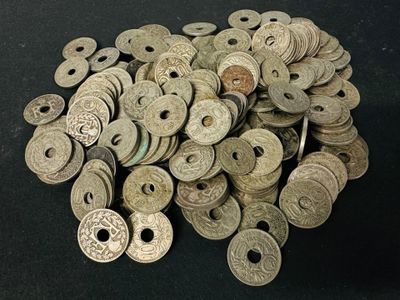 pile of ancient coins on a black surface