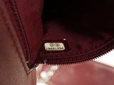 the inside of a red purse with a tag on it