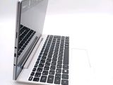 a white laptop with a black keyboard on a white surface