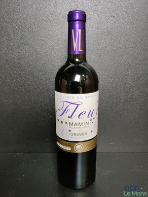 a close up of a bottle of wine on a table