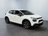 a white citrole is parked in a large room