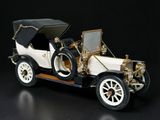 a model of an old car on a black surface