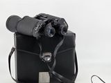 an old camera with a black case and a pair of binoculars on a white background