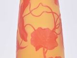 a red and yellow vase sitting on a white surface
