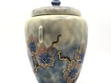 a blue and white vase with a flower design on it