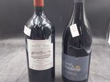 two bottles of wine sitting next to each other on a table
