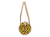 a yellow and black polka dot purse on a white background