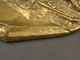 a gold statue of a man riding a horse on a rock