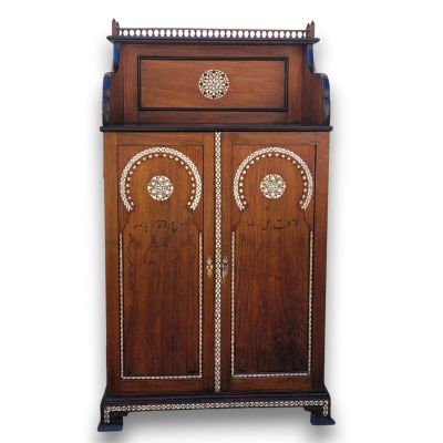 a wooden cabinet with two doors and a drawer on top of it