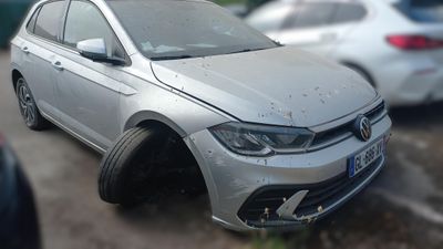 a silver car that is parked on the side of the road