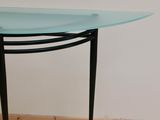 a table with a glass top on a tile floor