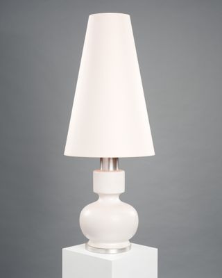 white table lamp with a white shade on top of it