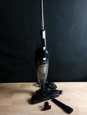 a black and white photo of a vacuum on a wooden table