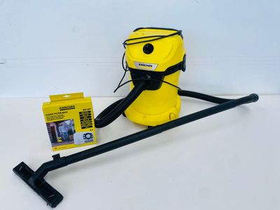a yellow vacuum cleaner with a black handle and a yellow box
