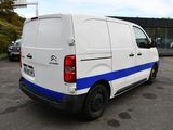a white van with blue stripes parked in a parking lot