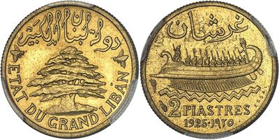 a close up of a gold coin with a tree on it