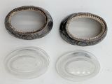 two empty glass bowls sitting on a white surface