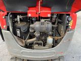 a small engine in the back of a red truck