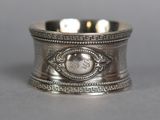 an antique silver napkin ring with a monogram on the front