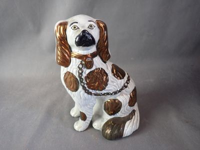 brown and white dog figurine sitting on a gray surface