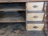 a wooden desk with three drawers on top of it